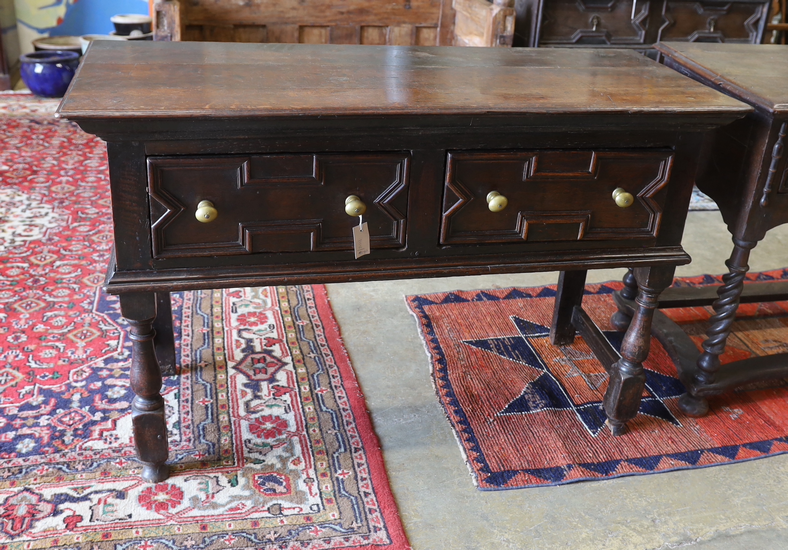 A small 18th century and later oak two drawer low dresser, width 133cm, depth 55cm, height 85cm